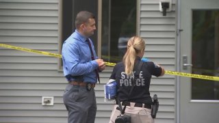 Investigators at the scene of a stabbing that left three people hurt in Holbrook, Massachusetts, early on Saturday, July 13, 2024.