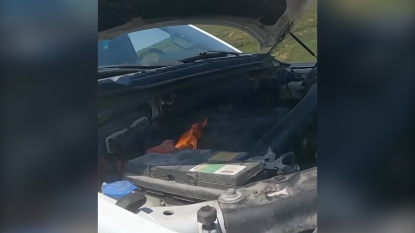 A fire under the hood of a truck.