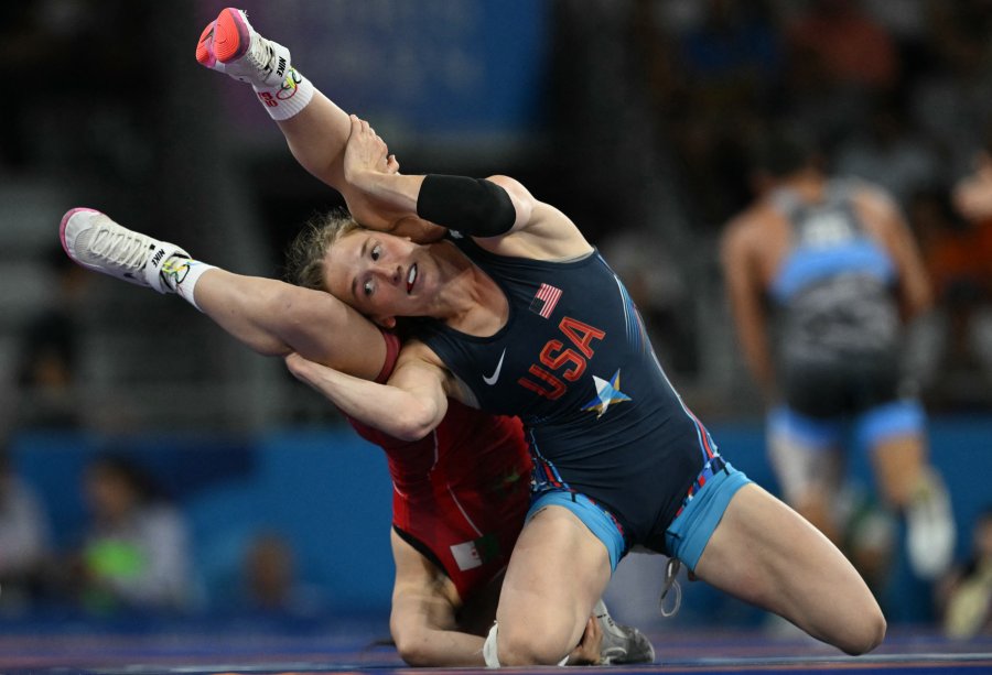 Algeria's Ibtissem Doudou wrestles US' Sarah Ann Hildebrandt (blue) in their women's freestle 50kg wrestling early rounds match at the Champ-de-Mars Arena during the Paris 2024 Olympic Games, in Paris on August 6, 2024