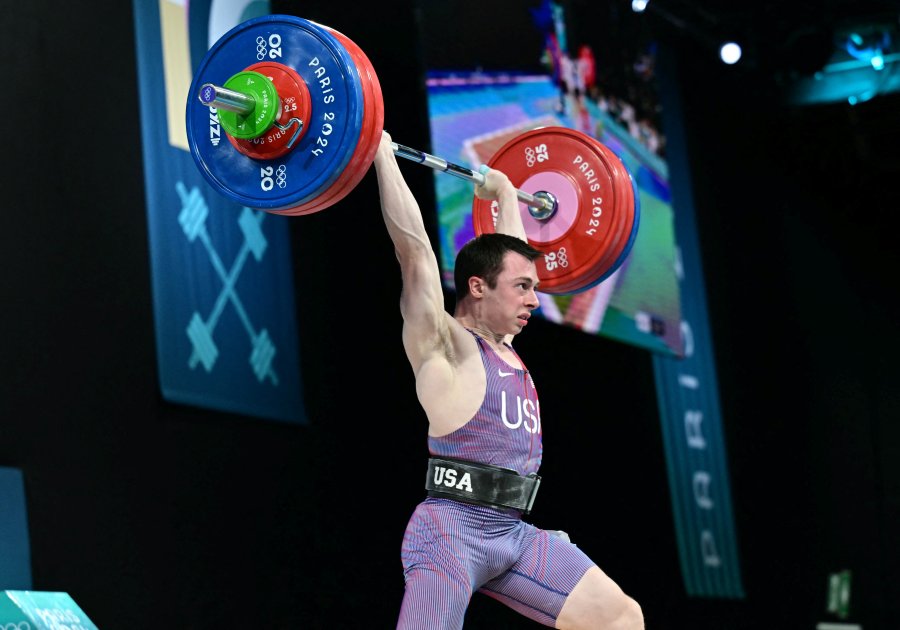 Hampton Morris competes in the men's -61kg weightlifting event