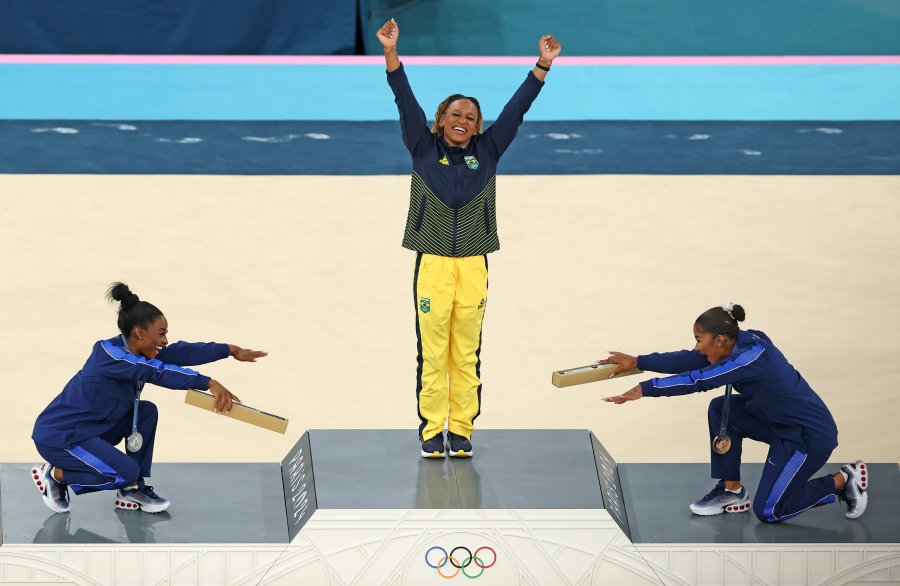 Gold medalist Rebeca Andrade of Team Brazil, silver medalist Simone Biles (L) of Team United States and bronze medalist Jordan Chiles (R) of Team United States celebrate on the podium at the Artistic Gymnastics Women's Floor Exercise Medal Ceremony on day ten of the Olympic Games Paris 2024 at Bercy Arena on August 05, 2024 in Paris, France