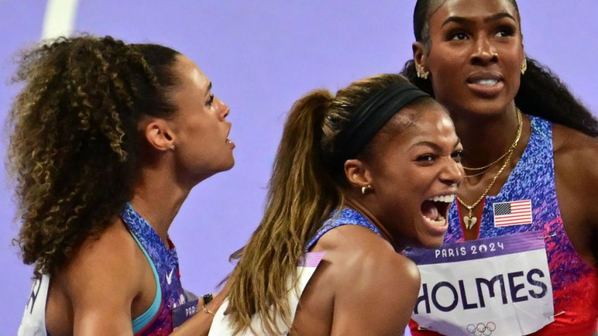 Gold medallists US’ Sydney Mclaughlin-Levrone, US’ Gabrielle Thomas and US’ Alexis Holmes celebrate after competing in the women’s 4x400m relay final of the athletics event at the Paris 2024 Olympic Games at Stade de France in Saint-Denis, north of Paris, on August 10, 2024. (Photo by Martin  BERNETTI / AFP) (Photo by MARTIN  BERNETTI/AFP via Getty Images)