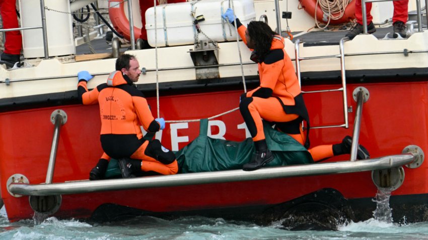 Divers of the Vigili del Fuoco, the Italian Corps. of Firefighters arrive with a body bag at the back of the boat in Porticello near Palermo, on August 21, 2024 two days after the British-flagged luxury yacht Bayesian sank.