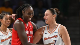 Tina Charles of the Atlanta Dream hugs Diana Taurasi of the Phoenix Mercury after becoming the WNBA’s No. 2 all-time scoring leader during the game between Atlanta Dream and the Phoenix Mercury at Gateway Center Arena on Aug. 21, 2024, in College Park, Georgia.