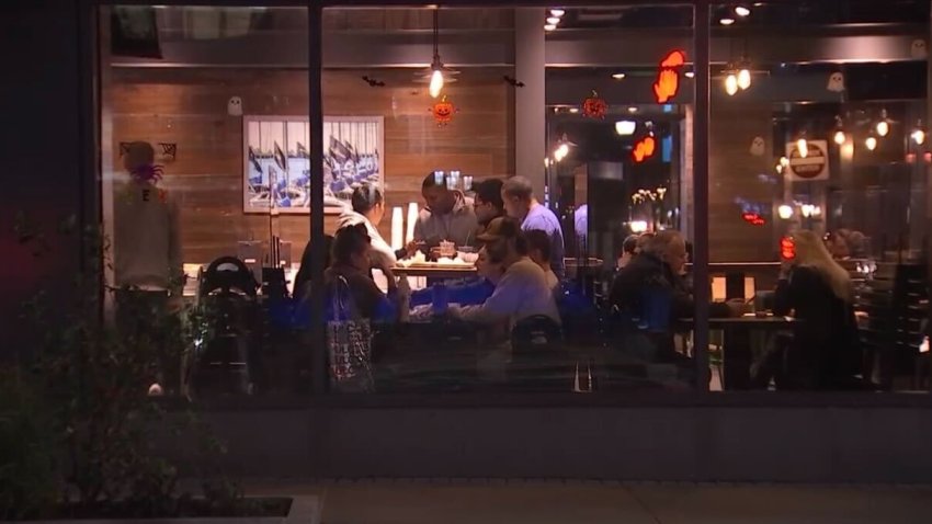 Group of people sitting at a restaurant table at night