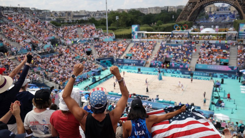 American fans cheer on volleyball players at the Eiffel Tower Stadium.