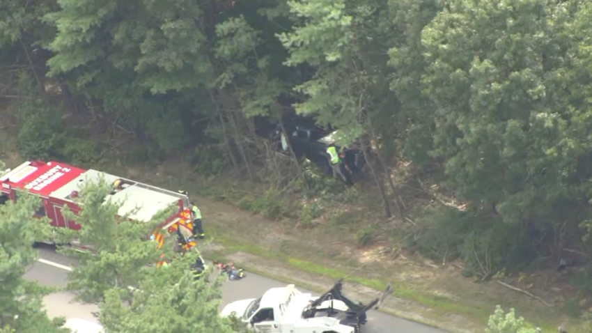 A vehicle in the trees near Route 3 in Duxbury, Massachusetts, on Wednesday, Aug. 21, 2024.