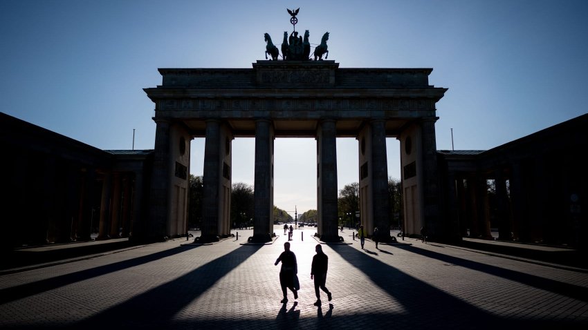 The Brandenburg Gate casts long shadows over the almost deserted Pariser Platz, April 15, 2020 in Berlin, Germany.