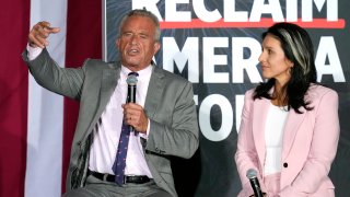 Robert F. Kennedy, Jr., left, speaks as former Democratic Rep. Tulsi Gabbard listens