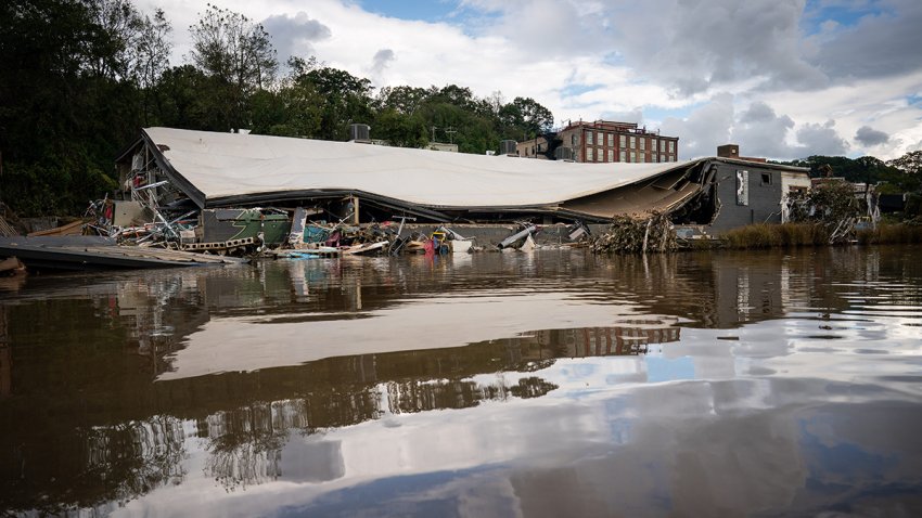 A damaged building is seen in flood waters left by Hurricane Helene in the River Arts District in Asheville, N.C., Monday, Sept. 30, 2024.