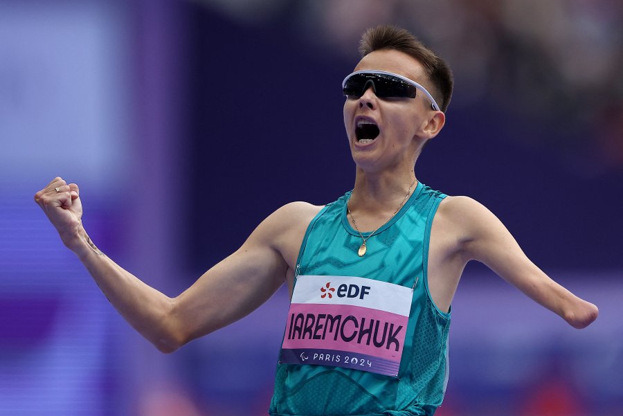 Neutral Paralympic Athlete Alelsandr Iaremchuk celebrates his victory after winning a gold medal in the Men's 1500m -T46 event during the Paris 2024 Paralympic Games at the Stade de France in Saint-Denis North of Paris on August 31 2024