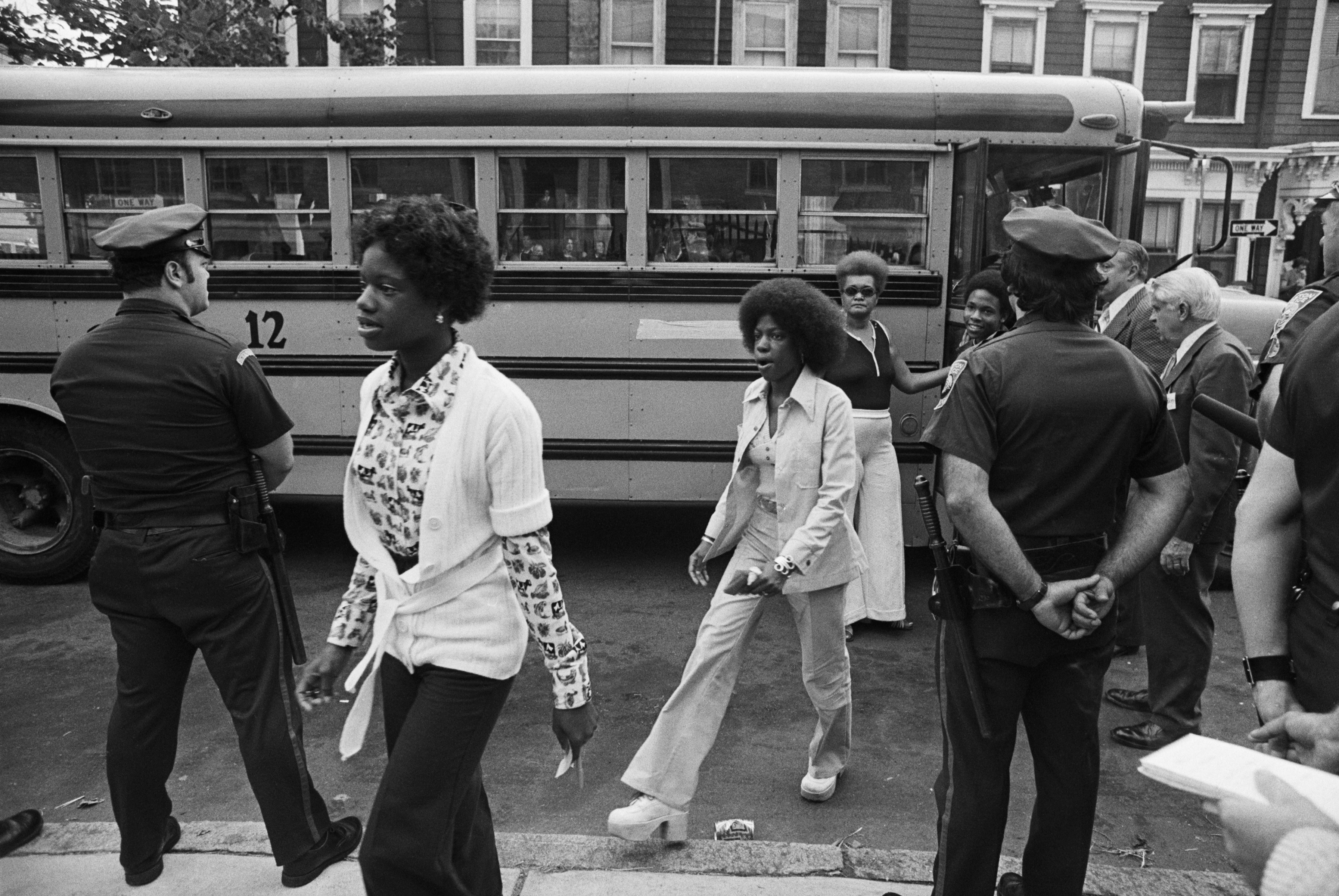 Sept. 12, 1974: As police stand guard, Black students arrive at the predominately all-white South Boston High School on the first day of classes under a federal court-ordered busing program aimed at desegregating the school system.