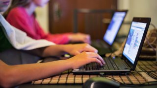 Kids using laptop.