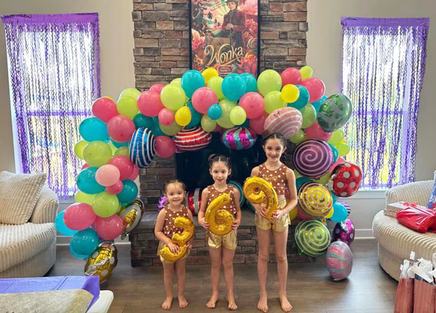 Three sisters pose with 3, 6 and 9 gold balloons