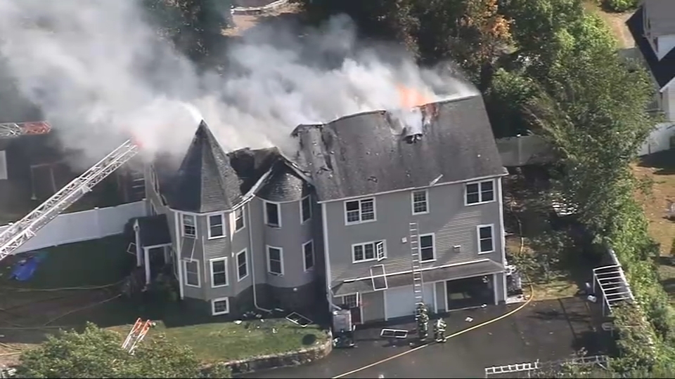 Smoke pours from a burning home in Quincy, Massachusetts, on Thursday, Sept. 12, 2024.