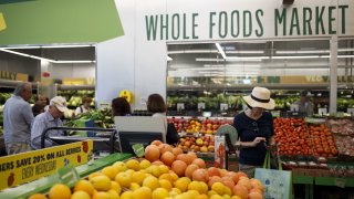 Customers shop for produce at a Whole Foods Market 365 location in Santa Monica, California.