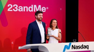 Nasdaq Jeff Thomas Senior Vice President and Anne Wojcicki, 23andMe Co-Founder & CEO pose with an opening ceremony gift before the remote ringing of the NASDAQ opening bell at the headquarters of DNA tech company 23andMe in Sunnyvale, California, U.S., June 17, 2021.