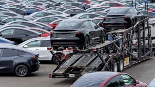 New Tesla Model 3 vehicles on a truck at a logistics drop zone in Seattle, Washington, US, on Thursday, Aug. 22, 2024.