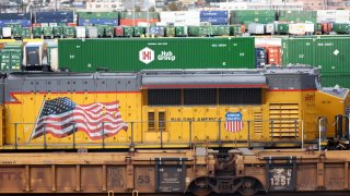 A freight engine and shipping containers are viewed in a Union Pacific Intermodal Terminal rail yard on November 21, 2022 in Los Angeles, California.