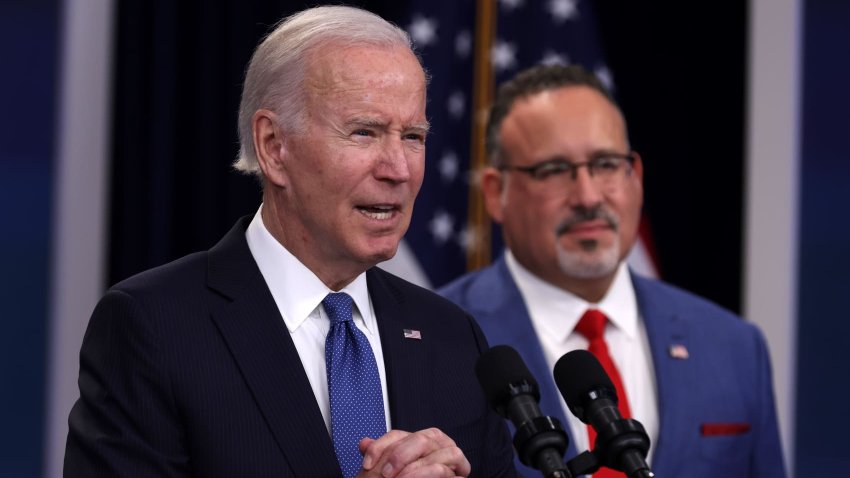 U.S. President Joe Biden speaks on the student debt relief plan as Secretary of Education Miguel Cardona listens on October 17, 2022.