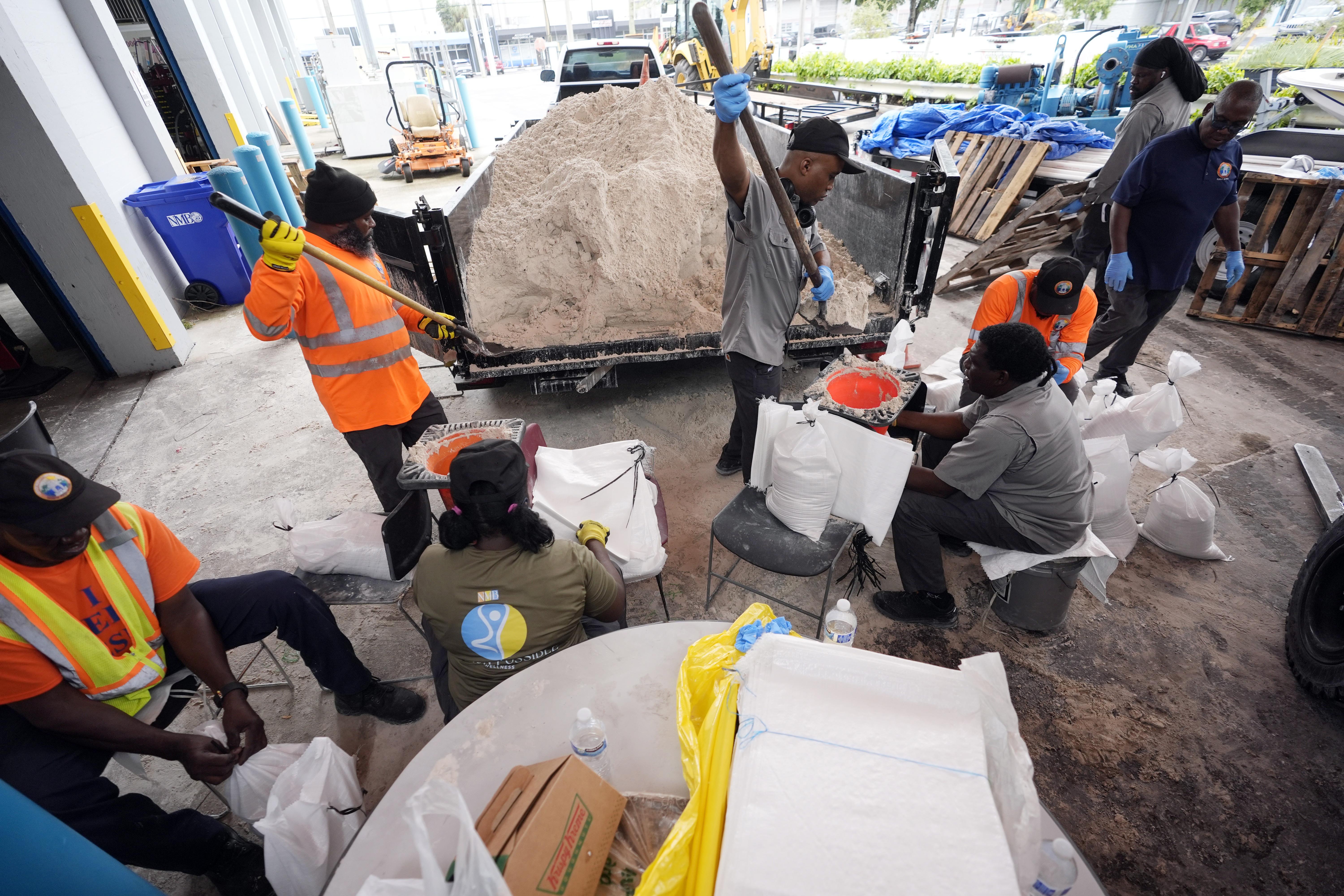 North Miami Beach, Fla., public service workers fill sandbags, to distribute to residents to help prevent flooding, as Hurricane Milton prepares to strike Florida, Tuesday, Oct. 8, 2024, in North Miami Beach.