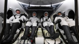 This photo provided by NASA shows Roscosmos cosmonaut Alexander Grebenkin, left, NASA astronauts Michael Barratt, second from left, Matthew Dominick, second from right, and Jeanette Epps, right, inside the SpaceX Dragon Endeavour spacecraft onboard the SpaceX recovery ship MEGAN shortly after having landed in the Gulf of Mexico off the coast of Pensacola, Florida, Friday, Oct. 25, 2024.