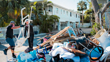 Workers at one of Brent Taylor’s construction sites removed debris Friday from a bathroom that recently sustained hurricane damage in Indian Rocks Beach, Fla.