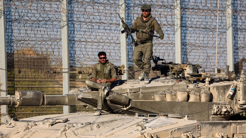 Israeli soldiers stay on a tank as they patrol along the Israel-Gaza border area on October 21, 2024, amid the ongoing war between Israel and the Hamas militant group.