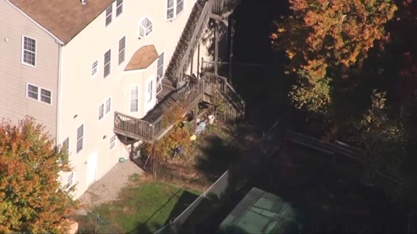 An aerial image of a home in Middleborough, Massachusetts. The trees are bright with fall foliage.