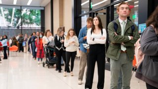 People wait in line to vote at a polling station at Martin Luther King Jr. Library in Washington, DC on Election Day, November 5, 2024.