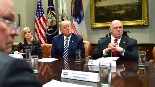 President Donald Trump (C) holds a law enforcement roundtable on sanctuary cities, in the Roosevelt Room at the White House on March 20, 2018 in Washington, D.C. Trump was joined by Attorney General Jeff Sessions (L), and Homeland Security Secretary Kirstjen Nielsen, and Thomas Homan, acting director of Immigration and Customs Enforcement.