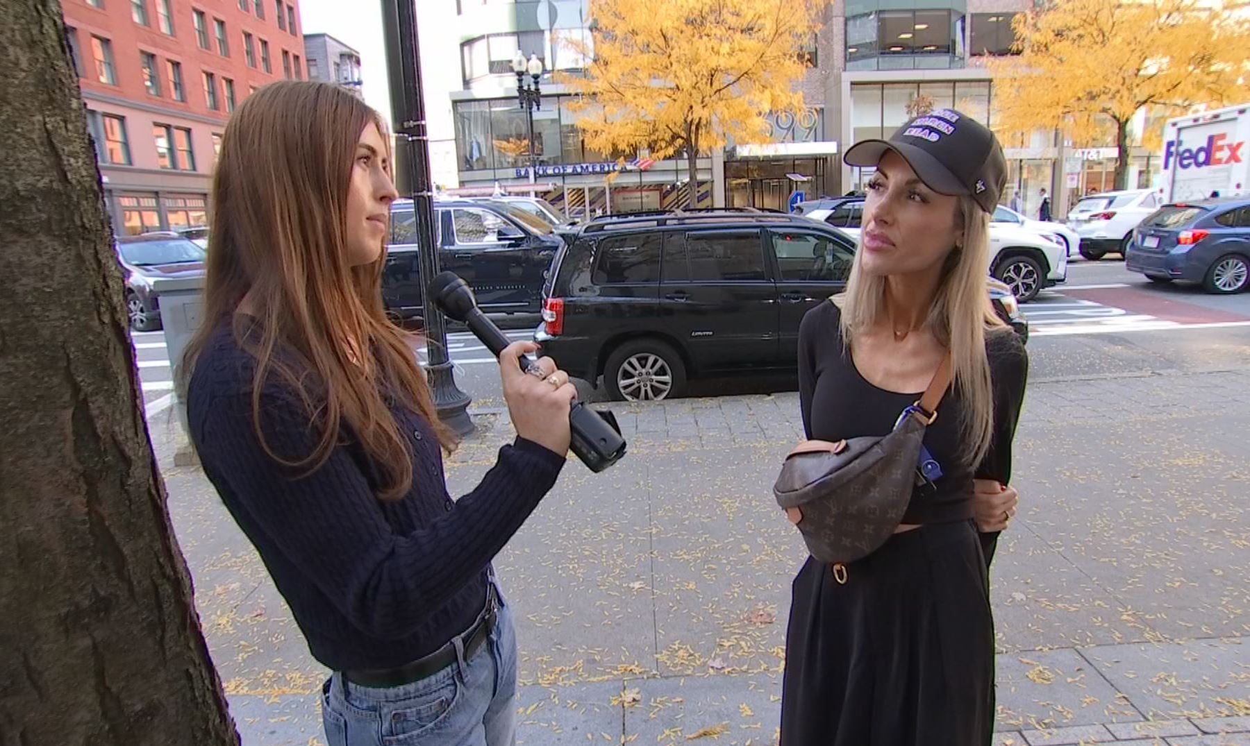 Clare Olson interviewing a woman in Boston about the Massachusetts State Police.