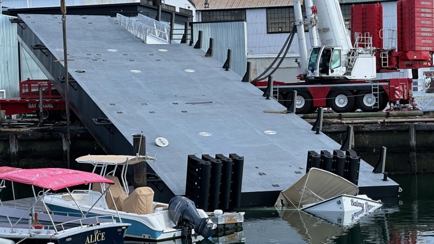 A boat was damaged when a crane moving part of a barge collapsed at a marina in East Boston Thursday.