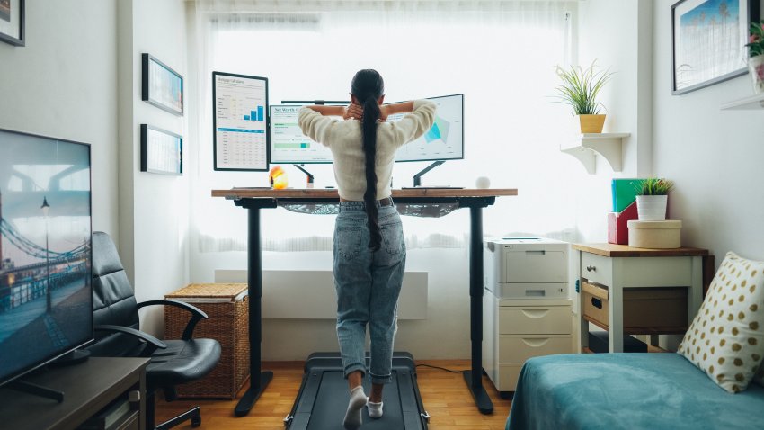 Woman at home office using a walking pad