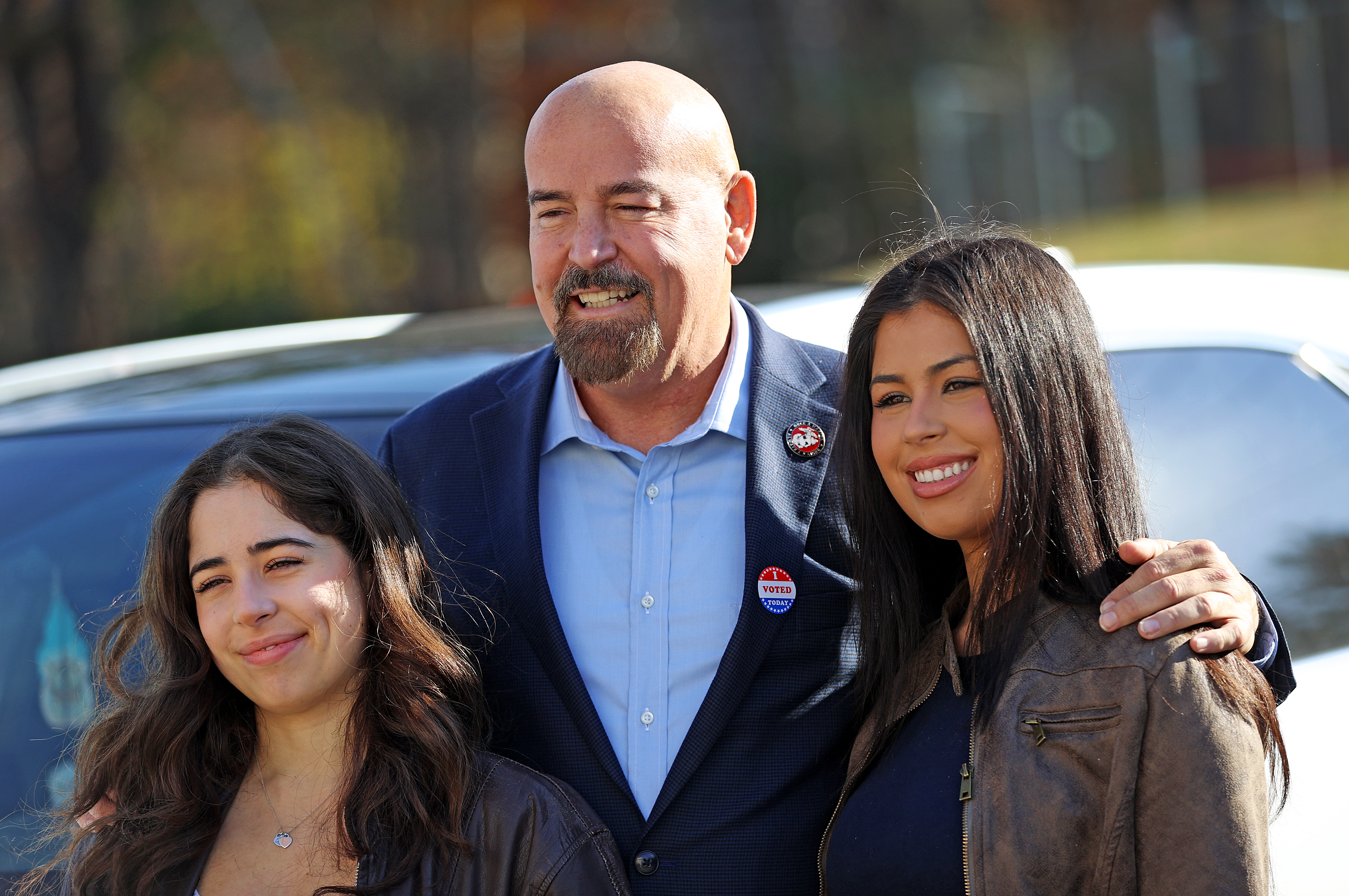 Bolton, MA – November 5: John Deaton poses for a photo with his daughters Olivia and Jordan after voting at Nashoba Regional High School. (Photo by David L. Ryan/The Boston Globe via Getty Images)