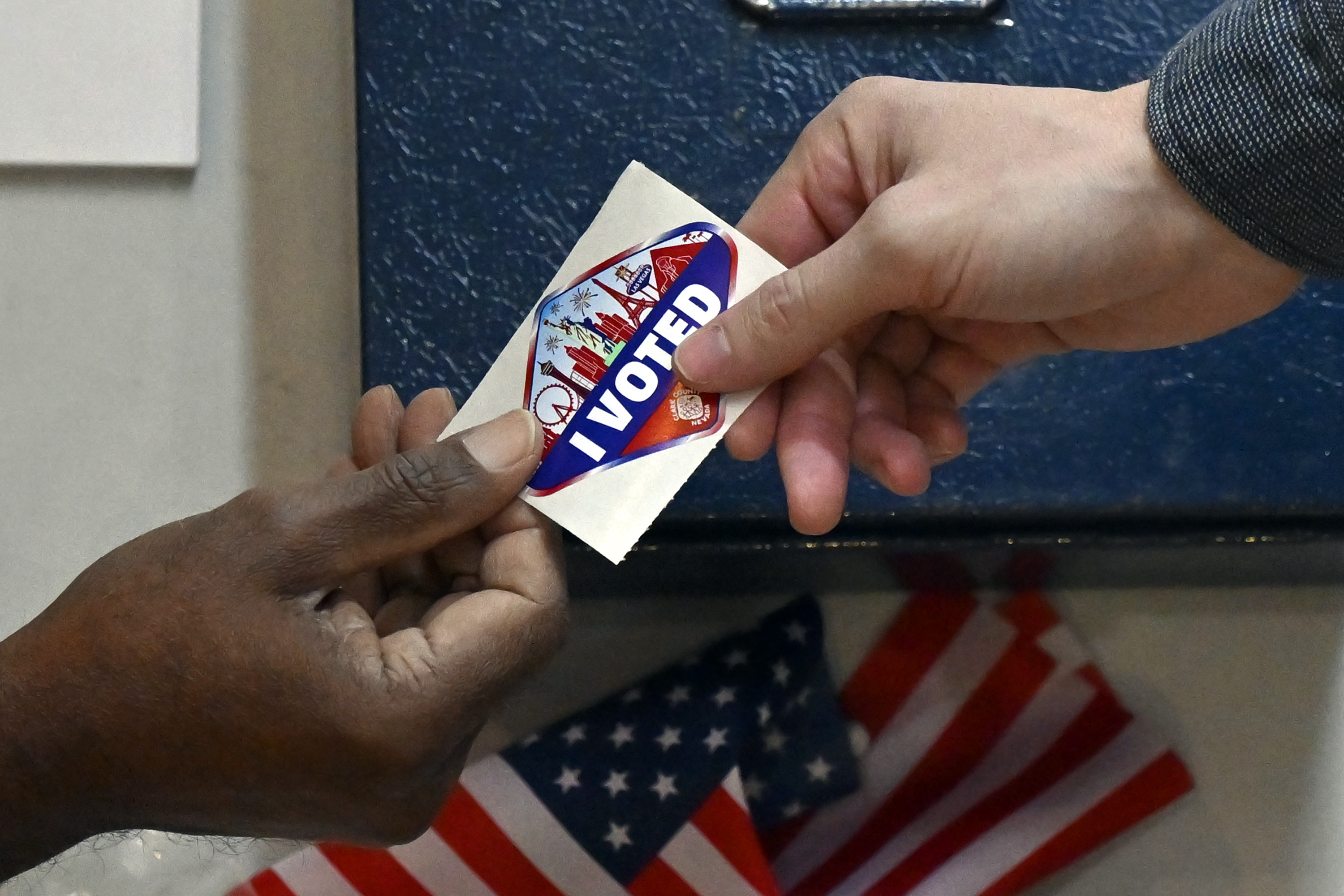 A voter receives a Las Vegas-themed “I Voted” sticker after casting their ballot inside the Galleria at Sunset mall on November 05, 2024 in Las Vegas, Nevada.