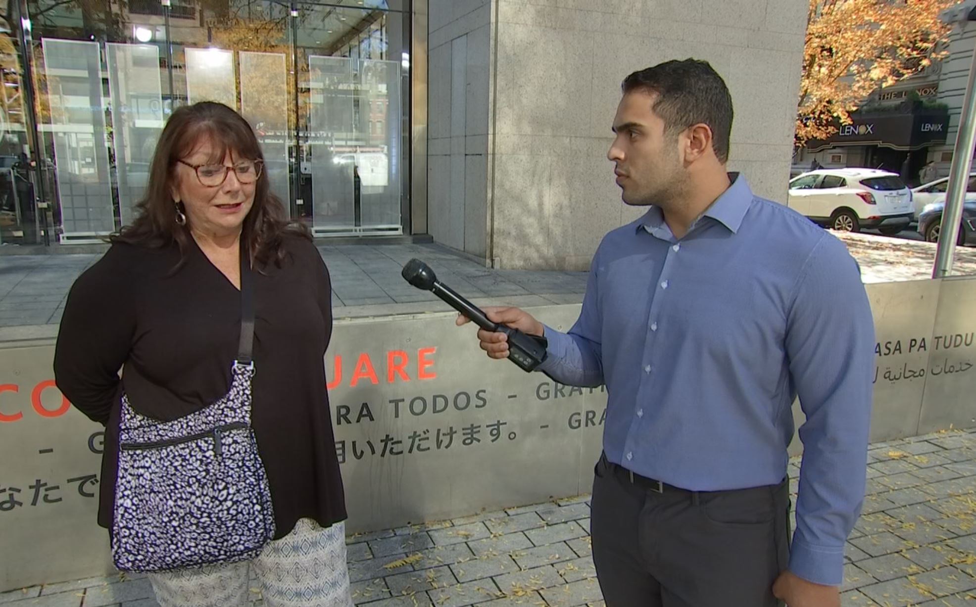 Michael Rodriguez interviewing a woman in Boston about the Massachusetts State Police.