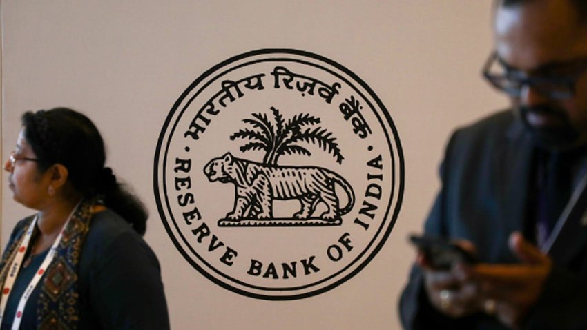 People stand in front of a Reserve Bank of India logo at the Global Fintech Fest in Mumbai, India, 5 September, 2023.