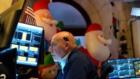 A trader works on the floor of the New York Stock Exchange (NYSE) at the opening bell on November 26, 2024, in New York City.