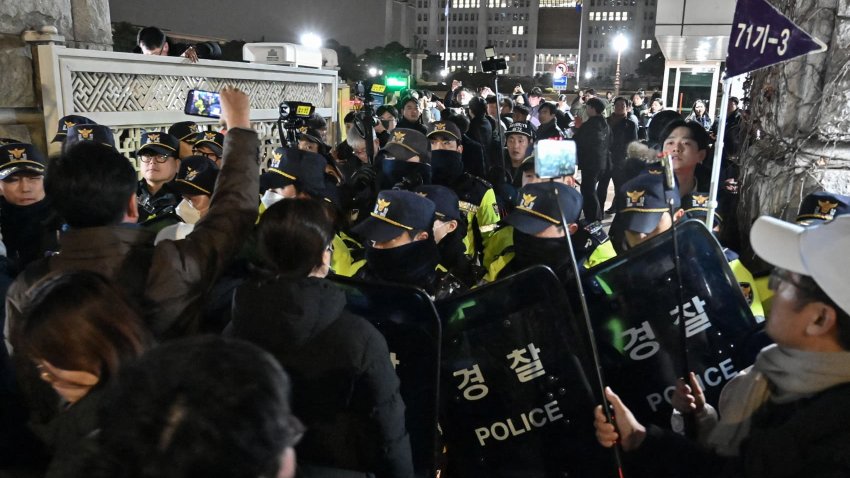 Police stand guard in front of the main gate of the National Assembly in Seoul on December 3, 2024, after South Korea’s President Yoon Suk Yeol declared emergency martial law. South Korea President Yoon on December 3 declared emergency martial law, saying the step was necessary to protect the country from “communist forces” amid parliamentary wrangling over a budget bill. 