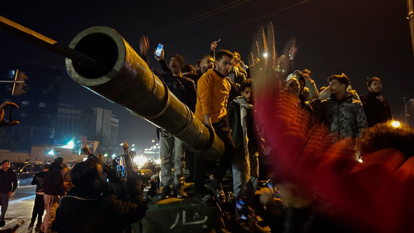 Syrians celebrate the arrival of opposition fighters in Damascus, Syria, Sunday Dec. 8, 2024.