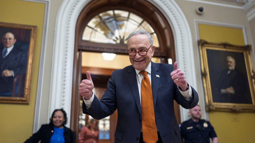 Senate Majority Leader Chuck Schumer, D-N.Y., celebrates as the Senate begins voting on the government funding bill