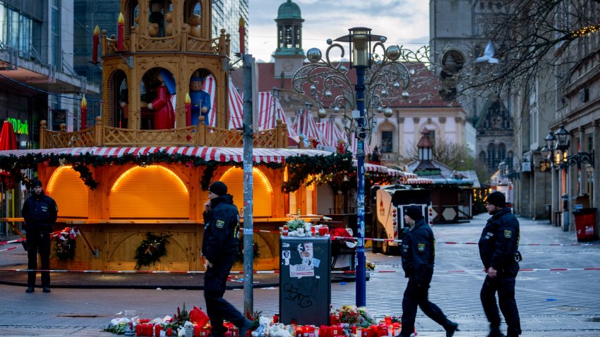 Policemen walk past the Christmas Market