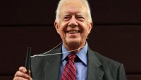 FILE - Former U.S. President Jimmy Carter poses for photographers with a water pipe filter, that is used to combat guinea worm disease, during a news conference to mark the launch of a campaign to eradicate the disease in central London, Wednesday, Oct. 5, 2011.