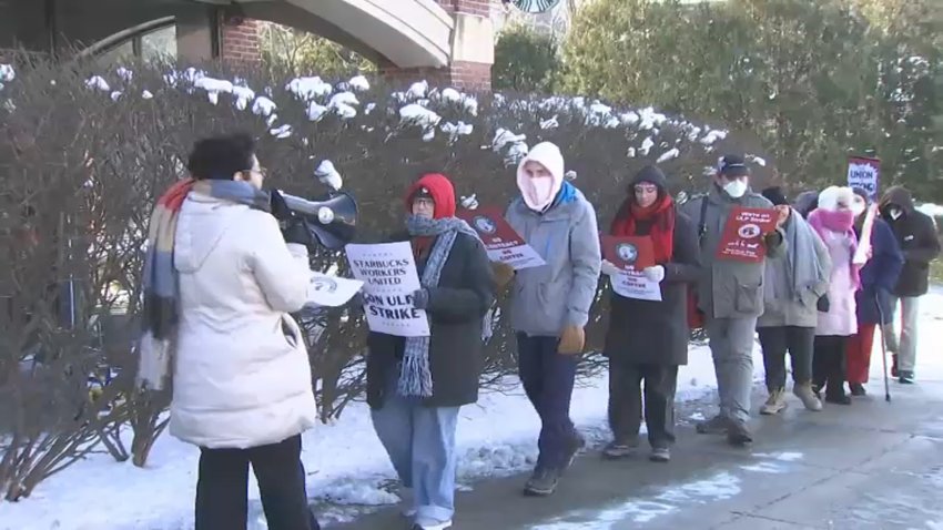 Starbucks workers strike outside a Boston store on Dec. 23, 2024.