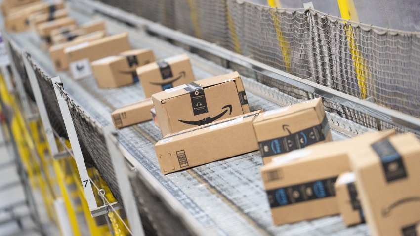 Packages move along a conveyor belt at an Amazon Fulfillment center on Cyber Monday in Robbinsville, New Jersey, US, on Monday, Nov. 27, 2023. An estimated 182 million people are planning to shop from Thanksgiving Day through Cyber Monday, the most since 2017, according to the National Retail Federation. Photographer: Jeenah Moon/Bloomberg via Getty Images