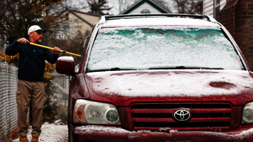 Boston, MA – December 5: A man clears snow from his car. (Photo by Craig F. Walker/The Boston Globe via Getty Images)