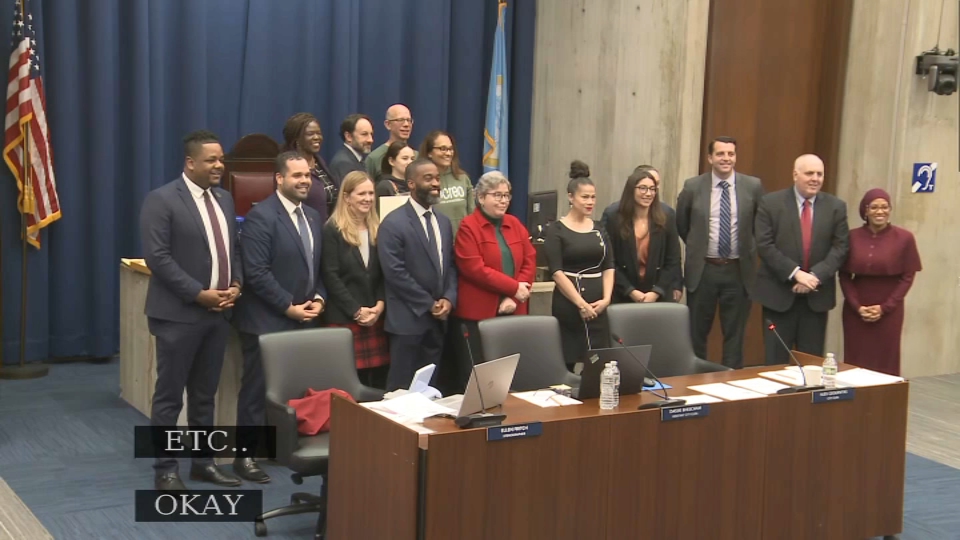 The members of Boston City Council, including, at right, Tania Fernandes Anderson, pose for a picture with the team behind a coffee shop departing City Hall during the Wednesday, Dec. 11, 2024, meeting.