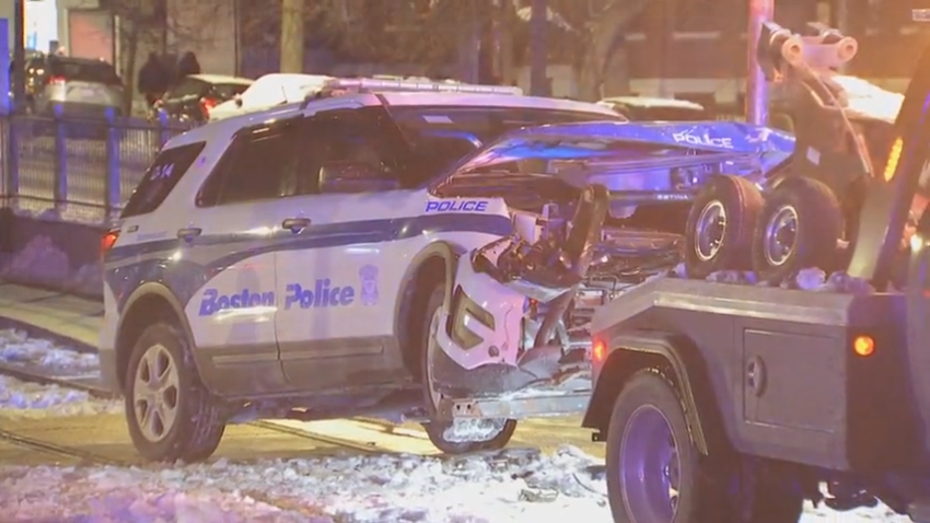 A crashed Boston police cruiser being towed from Green Line tracks Monday, Dec. 23, 2024.