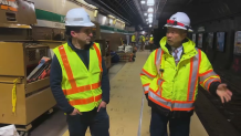 MBTA General Manager Phil Eng (at right) speaks to NBC10 Boston anchor Jeff Saperstone amid construction at a Green Line station.